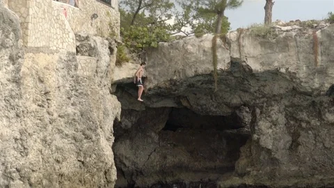 Cliff jumping at Ricks Cafe in Negril, Jamaica. Filmed in Super Slow Motion. Stock Footage 73138481