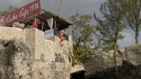 Cliff jumping at Ricks Cafe in Negril, Jamaica. Filmed in Super Slow Motion. Stock Footage 73138714