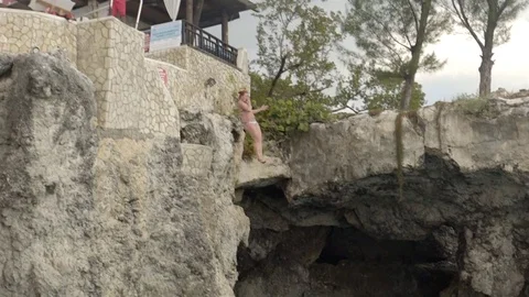 Cliff jumping at Ricks Cafe in Negril, Jamaica. Filmed in Super Slow Motion. Stock Footage 73138778