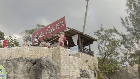Cliff jumping at Ricks Cafe in Negril, Jamaica. Filmed in Super Slow Motion. Stock Footage 73138828