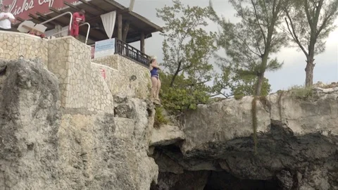 Cliff jumping at Ricks Cafe in Negril, Jamaica. Filmed in Super Slow Motion. Stock Footage 73138899