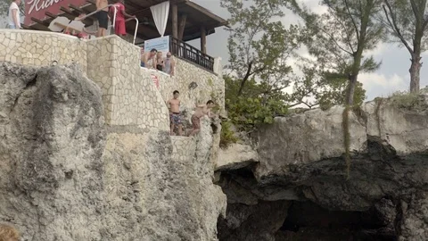 Cliff jumping at Ricks Cafe in Negril, Jamaica. Filmed in Super Slow Motion. Stock Footage 73139099
