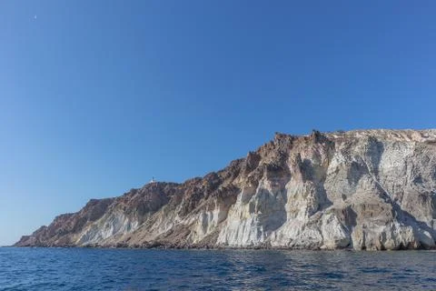 Cliff with lighthouse at top in Santorini. Stock Photos
