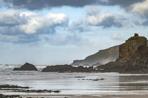 Cliff looking like a castle on the edge of a Cornwall beach Stock Photos