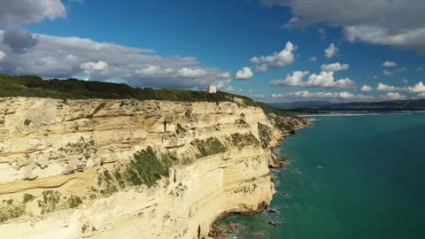 A cliff  rock rises above the turquoise sea. Italian stone pine forest. Stock Footage 300384875