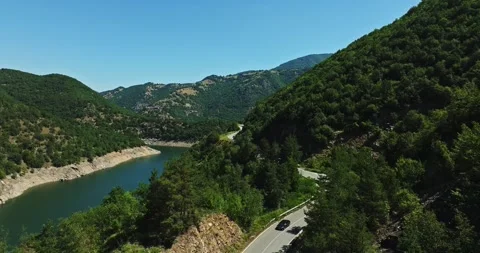 Cliff Side Road Overlooking River Basin On Busy Summer Day Opening Scene Video stock 289417426