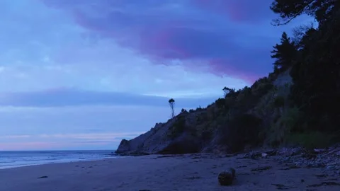 CLIFF STICKING OUT ON BEACH Stock Footage 253909673
