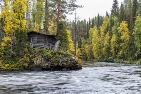 Cliff, stone wall, forest, waterfall and wild river view in autumn. Fall colo Stock Photos