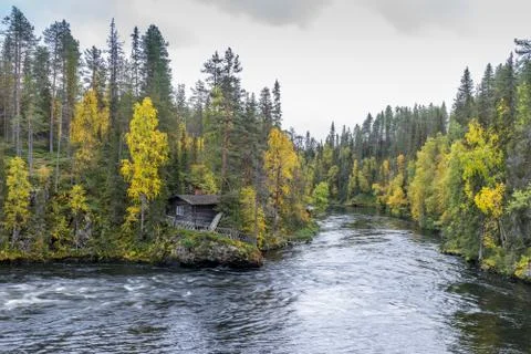 Cliff, stone wall, forest, waterfall and wild river view in autumn. Fall colo Stock Photos