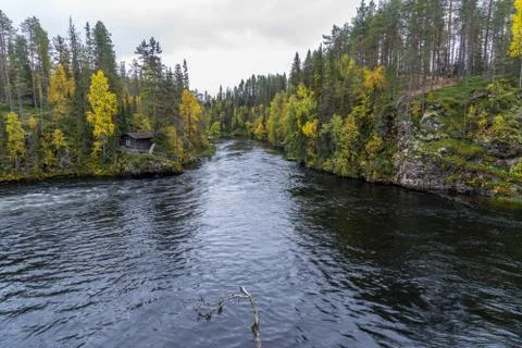 Cliff, stone wall, forest, waterfall and wild river view in autumn. Fall colo Stock Photos