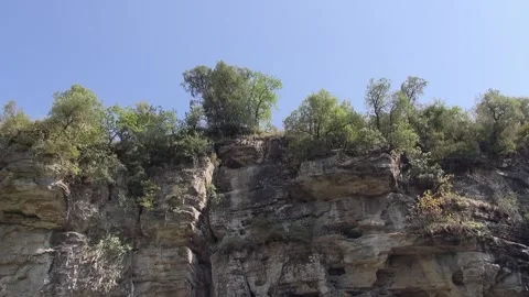 Cliff trees sky stone Foradada day sunlight low angle Stock Footage 329768755