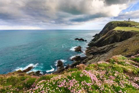 Cliff under cloudy sky Stock Photos