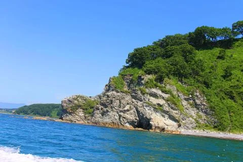 Cliff with vegetation Stock Photos