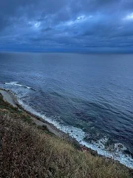 Cliff View Overlooking the Pacific Ocean and Storm Clouds Stock Photos