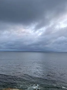Cliff View Overlooking the Pacific Ocean and Storm Clouds Stock Photos