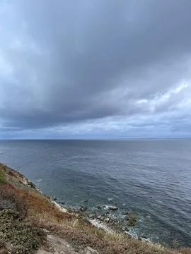 Cliff View Overlooking the Pacific Ocean and Storm Clouds Stock Photos