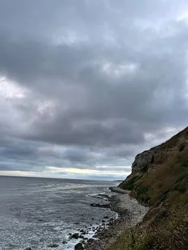 Cliff View Overlooking the Pacific Ocean and Storm Clouds Stock Photos