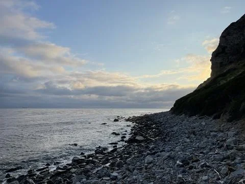 Cliff View Overlooking the Pacific Ocean and Storm Clouds During Sunset Photos