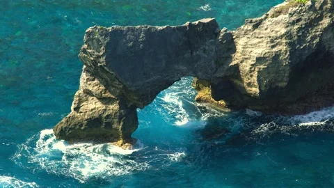 A cliff washed by azure wavy ocean water in the Caribbean. Stock Footage 273141449