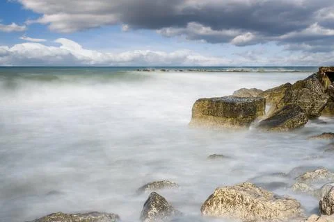 Cliffs in Adriatic sea. The sun's rays reflecting on the rocks. Long exposure. Foto stock