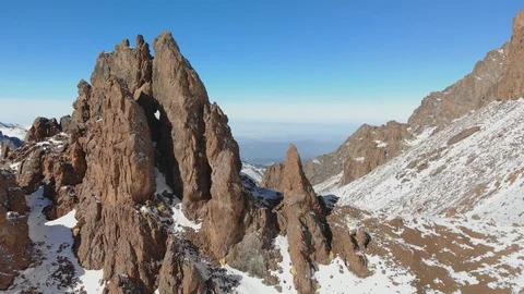 Cliffs among the mountains in the snow Stock Footage 123522310