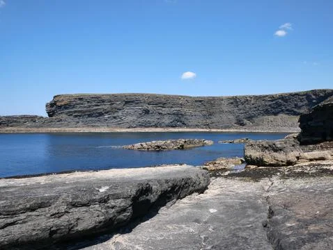 Cliffs and Atlantic ocean, clouds, rocks and laguna, beauty in nature. Vaca.. Stock Photos