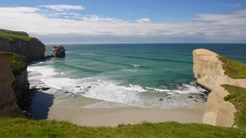 The cliffs and beach at Tunnel Beach on a sunny day. Otago, New Zealand. Stock Footage 134672391