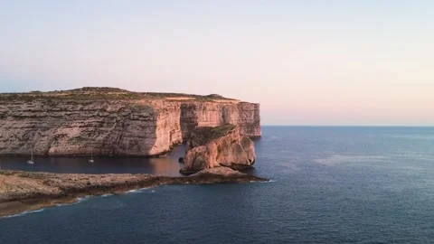 Cliffs and Boats by the Sea at Sunset in Malta During Early Evening Hours. Gozo, Stock Footage 334854858