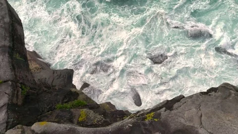 Cliffs and breaking waves from aerial top down view in slow motion Stock Footage 347684102
