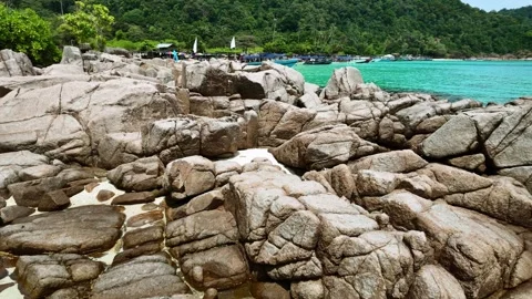 Cliffs and coastline with turquoise water and boats on the turtle beach of Stock Footage 321012089
