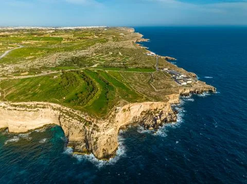Cliffs and green fields, hills of Maltese island. Mediterranean sea Stock Photos