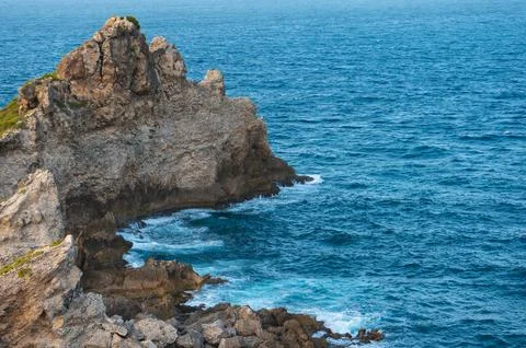 Cliffs and ocean breaking on rocks seen from Pointe des Chateaux Stock Photos