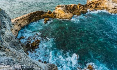 Cliffs and ocean breaking on rocks seen from Pointe des Chateaux Stock Photos