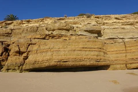 Cliffs and rock formations on the beach of Salema on the Algarve Stock Photos