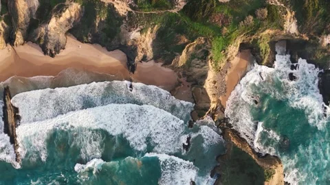 Cliffs and rocks washed by ocean waves. Praia dos Alteirinhos in Portugal Stock Footage 265024520