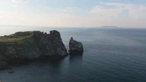 Cliffs and Sea Stack at Ireland’s Eye on Clear Summer Day Stock Footage 339409582