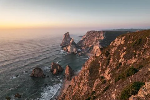 Cliffs and sea at sunset Stock Photos