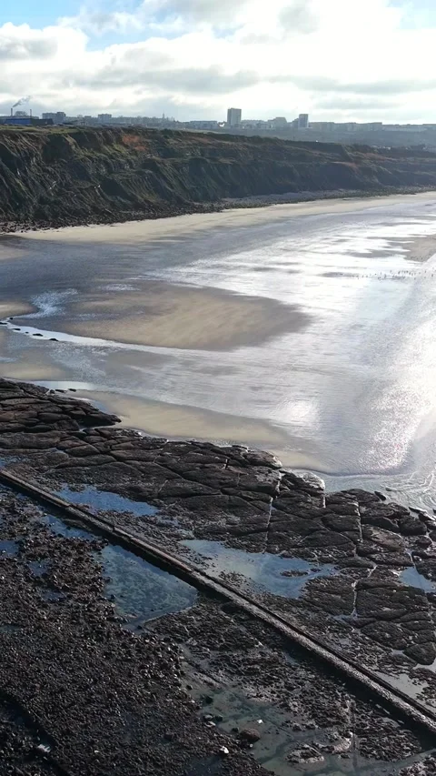 Cliffs and shining beach at low tide near Boulogne-sur-Mer, vertical Stock Footage 347178960