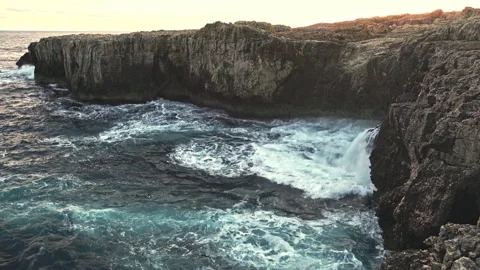 The cliffs and the stormy waves of the sea at the Plemmirio Nature Reserve Stock Footage 233478042