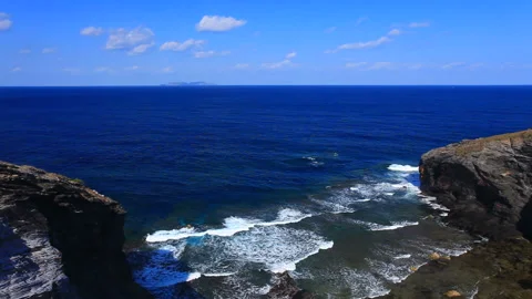 Cliffs and Waves of Onnese Cape and Tonaki Island Stock Footage 330467092