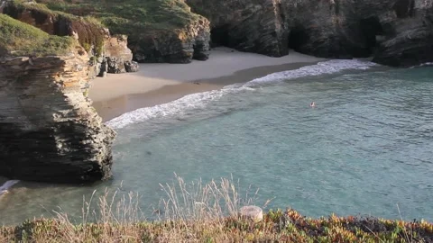 Cliffs, beach and cold sea water in summer Stock Footage 210154481