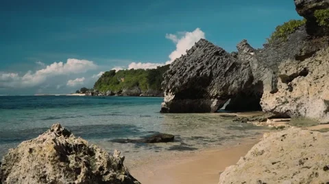 Cliffs on a beach, rocks and clear turquoise water Stock Footage 63579626