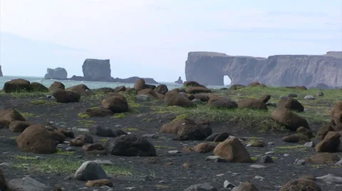 Cliffs from black sand beach with large rocks Stock Footage 37586609