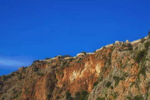 Cliffs with castle wall Stock Photos
