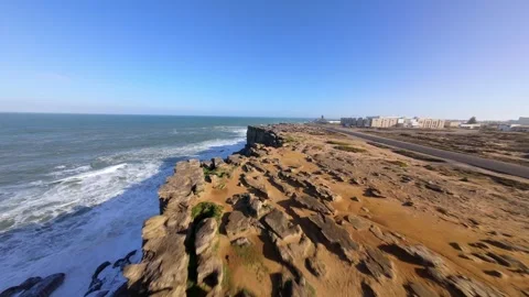 Cliffs crash into ocean under bright sun 스톡 동영상 346077129