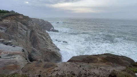 Cliffs drop to the Pacific Ocean on the Oregon Coast Stock Footage 329448799