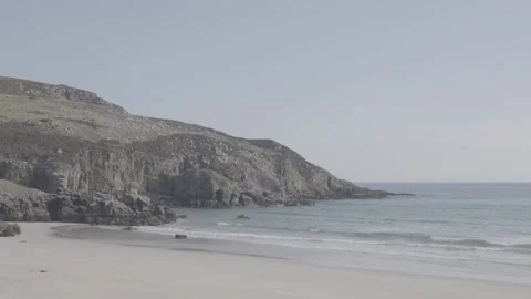 Cliffs at the edge of a sandy beach on a perfect spring day Stock Footage 159421529