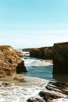 Cliffs   form   shadows   by   the   sea Stock Photos