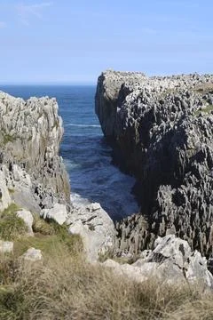The Cliffs of Hell with beautiful rock formations and coves in Ribadesella .. Stock Photos