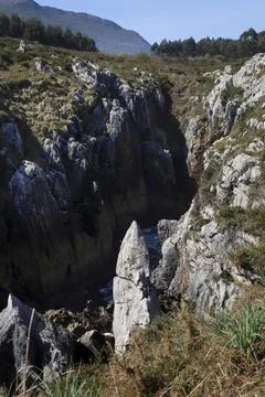 The Cliffs of Hell with beautiful rock formations and coves in Ribadesella .. Stock Photos